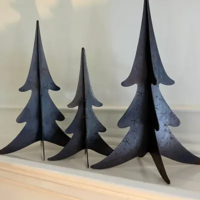 Sale Photo Thumbnail #106: Set of three rustic metal Christmas tree tabletop decorations with stamped star details, featuring a three-dimensional interlocking design.