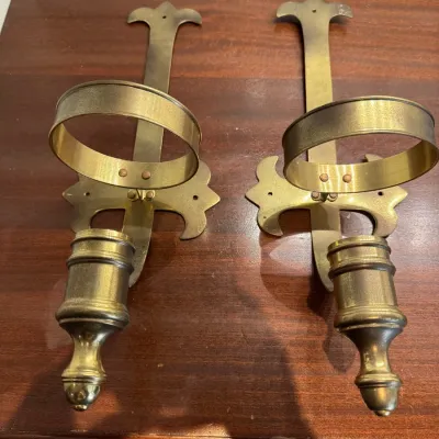 Sale Photo Thumbnail #103: Pair of vintage brass wall sconces featuring fleur-de-lis backplates and hurricane lamp holders with candle sockets.