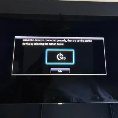 Wall-mounted flat-screen television displaying an on-screen connection prompt.