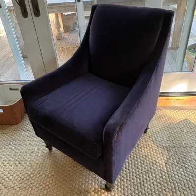 Sale Photo Thumbnail #120: Contemporary dark purple velvet armchair featuring a sloped track arm design and dark turned wooden legs.