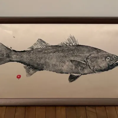 Framed Gyotaku Japanese fish rub print featuring a detailed black and white depiction of a fish with a red artist chop mark, set in a...