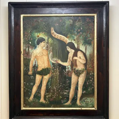 Sale Photo Thumbnail #159: Framed folk art oil painting depicting Adam and Eve in the Garden of Eden, housed in a dark wood frame with a gilded inner lip.