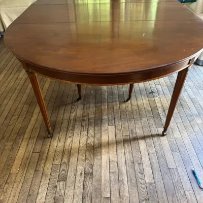Sale Photo Thumbnail #158: Antique mahogany drop-leaf extension dining table with tapered legs on brass casters.