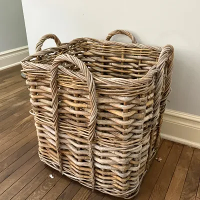 Large, square woven rattan basket with integrated carrying handles, featuring a thick natural wicker weave.