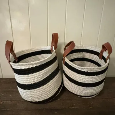 Sale Photo Thumbnail #127: Pair of modern black and white striped woven rope storage baskets featuring brown leather handles.