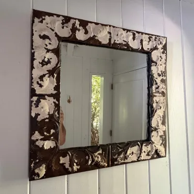 Sale Photo Thumbnail #121: Rustic wall mirror framed with distressed, painted tin ceiling tiles featuring an embossed scroll design.