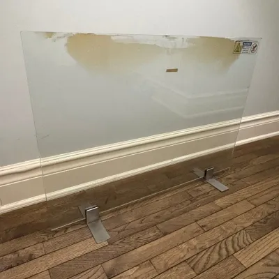 Sale Photo Thumbnail #108: Modern clear glass freestanding fireplace screen with brushed metal feet.