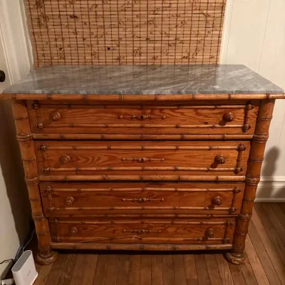 Antique faux bamboo pine dresser with a gray marble top and four drawers.
