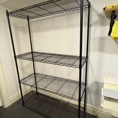 Sale Photo Thumbnail #140: Four-tier black wire metal shelving unit in good condition.