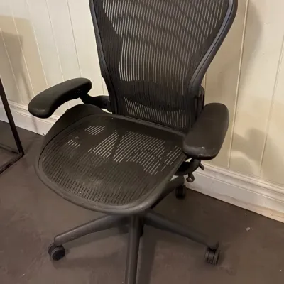Sale Photo Thumbnail #126: Herman Miller Aeron ergonomic office chair in black mesh with a five-star caster base.