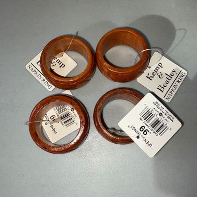 Sale Photo Thumbnail #76: Set of 4 carved wooden napkin rings with a warm brown finish and spiral/swirl carved design. Made in the Philippines. New old stock with original retail tags attached from Linens-N-Things.