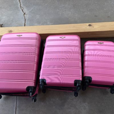 Sale Photo Thumbnail #93: Matching 3-piece nesting set of pink metallic hard-side spinner suitcases. Includes large, medium, and small/carry-on sizes. Features 360-degree dual spinner wheels, textured hardshell exterior, top handles, and full zipper closures. Appears gently used w