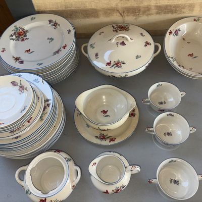 Sale Photo Thumbnail #291: Large set of fine porcelain or china dinnerware featuring delicate hand-painted style floral bouquets and blue rim trim. Includes dinner plates, side plates, saucers, dual-handled soup bouillon cups, a creamer, covered sugar bowl, gravy boat with attached