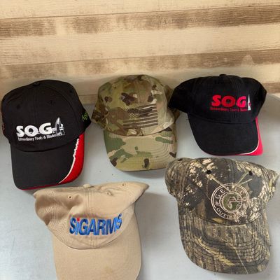 Sale Photo Thumbnail #97: Lot of 5 promotional and tactical baseball caps/hats.  Items show light to moderate wear consistent with previous use, including minor fabric creasing and faint spots.