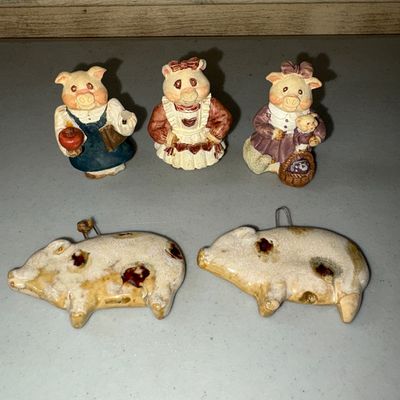 Sale Photo Thumbnail #62: Collection of 5 ceramic/resin pig items including three small standing pig figurines dressed in clothing and two ceramic spotted pig wall hanging decor pieces with metal loops on top. Overall good pre-owned condition with minor surface wear consistent wit
