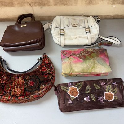 Sale Photo Thumbnail #43: Collection of 5 assorted women's handbags and clutches. Includes a white Guess crossbody shoulder bag, a brown leatherette handbag, a crescent-shaped tapestry shoulder bag, a painted/floral leather clutch, and a brown satin embroidered floral clutch with 