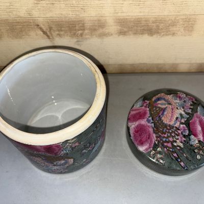 Sale Photo Thumbnail #205: Decorative ceramic lidded container or tea caddy featuring vibrant pink floral motifs and a phoenix/bird design on a dark green textured ground with gold accents. Marked on the bottom 'NOT FOR FOOD USE - ARTICLE MAY POISON THE FOOD - FOR DECORATIVE PURPOS