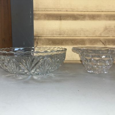 Sale Photo Thumbnail #285: A lot of two vintage clear pressed glass decorative pieces. Includes one wide shallow serving bowl with a fan and starburst pattern and scalloped rim, and one smaller raised bowl with a diamond/cube pressed pattern. Both pieces appear to be in good condit