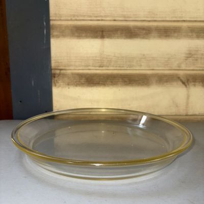 Sale Photo Thumbnail #325: Clear glass round pie plate with a lip edge. Appears to be in good pre-owned condition with minor surface wear from use. Ideal for baking or food service.
10in