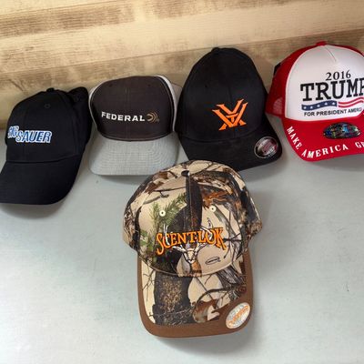 Sale Photo Thumbnail #95: Lot of 5 graphic hats and baseball caps including ScentLok camo hat, and a 2016 Trump Make America Great Again hat. Items appear to be in good, lightly used to unused condition.