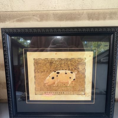 Sale Photo Thumbnail #368: Framed wall art featuring an illustration of "The Gloucester Old Spot" pig overlaid on an antique-style map of Gloucestershire. Housed in a dark textured/rope-twist style frame with double matting. Frame shows light wear. Overall good pre-owned condition.