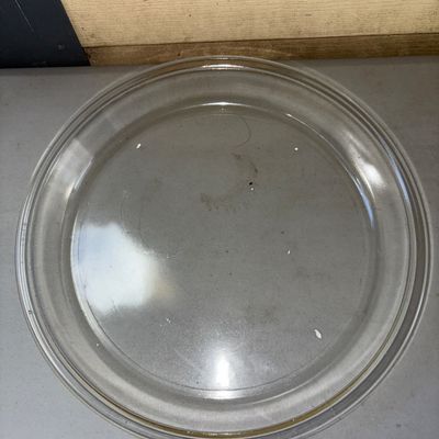 Sale Photo Thumbnail #324: Clear glass round pie plate with a lip edge. Appears to be in good pre-owned condition with minor surface wear from use. Ideal for baking or food service.
10in