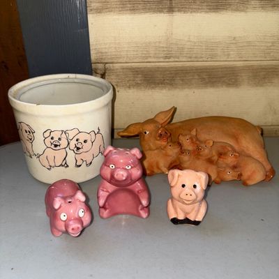 Sale Photo Thumbnail #233: A charming collection of pig-themed kitchen and home decor items. Includes a ceramic crock decorated with pig illustrations, two pairs of pink pig salt and pepper shakers, a small sitting pig figurine, and a large resin or composite sow with nursing pigle