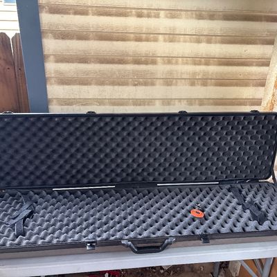 Sale Photo Thumbnail #109: Hard plastic gun case featuring egg crate foam interior lining and secure latches. Designed to hold long guns, rifles, or shotguns. Shows minimal exterior wear and is in good overall condition.