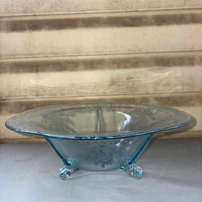 Sale Photo Thumbnail #331: A light blue Depression-style pressed glass bowl featuring an etched floral and ribbon pattern around the rim and body. The interior is divided into three sections with small molded dividers. Supported by three small glass feet. Good condition with no vis