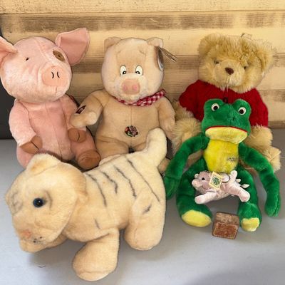 Sale Photo Thumbnail #11: 6 plush & 1 playblock.
Assortment of stuffed animal plush toys featuring two pigs, a teddy bear in a red sweater, a green frog, a plush tiger/leopard, a small pig plush keychain, and a small wooden alphabet block. Items show light wear consistent with gen