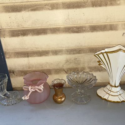 Sale Photo Thumbnail #207: Collection of 5 decorative glassware and ceramic items including a clear pressed glass cornucopia vase, a pink satin glass rose bowl/pouch vase with braided cord accent, a small amber speckled glass vase, a clear cut/pressed glass pedestal compote bowl, a