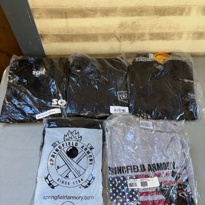 Sale Photo Thumbnail #225: Group of 5 graphic t-shirts, all individually packaged in plastic wrapping. Includes promotional and branded apparel. Items appear unused and in new condition in original sealed bags.
Sizes L-XL