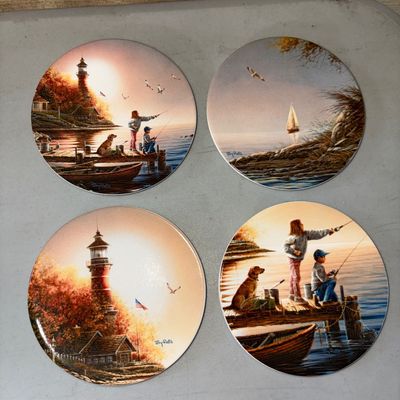 Sale Photo Thumbnail #82: 4.5in on all
A set of four round ceramic coasters featuring artwork by Terry Redlin depicting lighthouses, fishing scenes, and sailboats. Bright colors with glossy finish. Appears to be in good pre-owned condition with no visible cracks or chips.