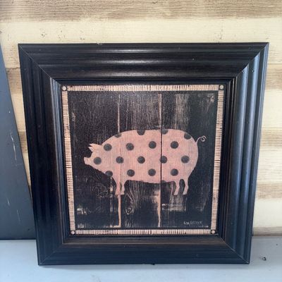 Sale Photo Thumbnail #369: Framed folk art style print depicting a pink polka dot pig on a dark textured background, signed Lisa Hilliker in lower right. Housed in a thick black wooden frame. Good condition with light surface wear.
14X14in