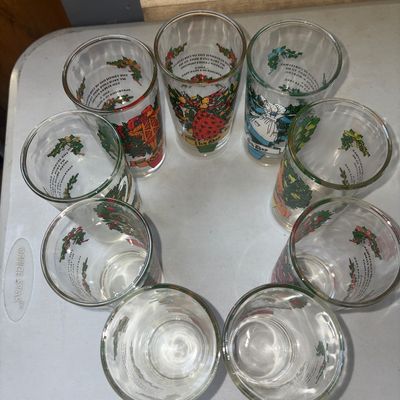 Sale Photo Thumbnail #284: Set of vintage clear glass drinking tumblers featuring colorful illustrations for the Twelve Days of Christmas. Each glass displays a day's verse and corresponding imagery, such as '1st Day' with a partridge in a pear tree and '2nd Day' with turtle doves.