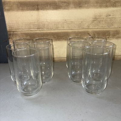 Sale Photo Thumbnail #288: A set of eight matching clear glass highball tumblers featuring a cylindrical shape with rounded bases. All glasses appear to be in good condition with no visible chips or cracks.
3.5in tall