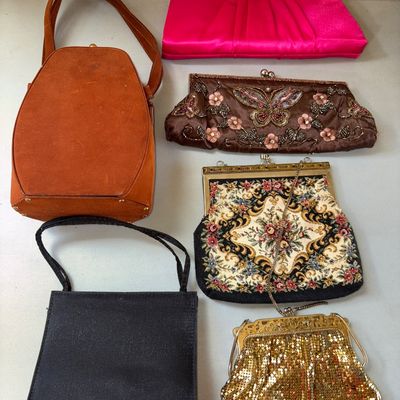Sale Photo Thumbnail #44: A collection of 6 assorted women's handbags and evening clutches. Includes a brown suede handbag with top handle, a pink satin clutch, a brown beaded butterfly motif clutch, a woven tapestry style purse with chain strap, a small black shoulder bag, and a 