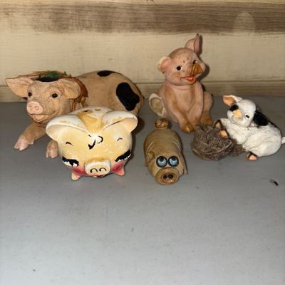 Sale Photo Thumbnail #25: Collection of 5 pig-themed decorative figurines and knick-knacks in various styles and materials, including resin and ceramic/pottery. Includes a spotted pig, salt/pepper shaker style pig, miniature figurines, and a sitting pig. Note: The sitting pig figu
