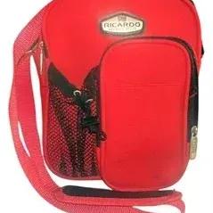 Red Ricardo Beverly Hills small travel shoulder bag with adjustable strap and front mesh pocket.