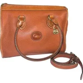 Vintage Dooney & Bourke All-Weather Leather satchel bag in tan with brass duck fob and detachable shoulder strap.