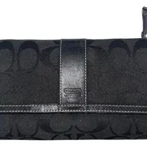 Coach black signature jacquard wallet featuring black leather trim, contrast stitching, and a snap closure.