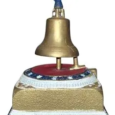 Vintage cast iron mechanical Liberty Bell bank featuring a blue eagle finial and patriotic red, white, and blue painted details.