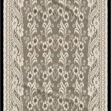 Off-white lace table runner with intricate floral and scrollwork patterns and scalloped edges.