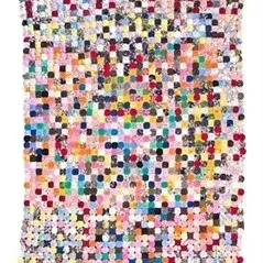 Handmade vintage postage stamp yo-yo quilt featuring a colorful mosaic of fabric circles.