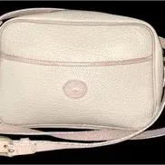 Vintage Dooney & Bourke light pink pebbled leather camera bag crossbody purse with duck logo patch and adjustable shoulder strap.