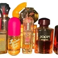 Collection of vintage fragrance and perfume bottles, including Love's Baby Soft, Joop! Homme, Ciara, and Grove, showing varying fill...