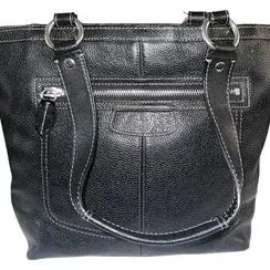 Black pebbled leather tote bag featuring contrast stitching, silver-tone hardware rings, and a front zippered pocket.