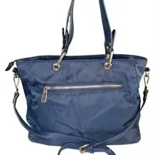 Navy blue nylon tote bag featuring double shoulder handles, a detachable crossbody strap, silver-tone hardware, and a exterior zippered...
