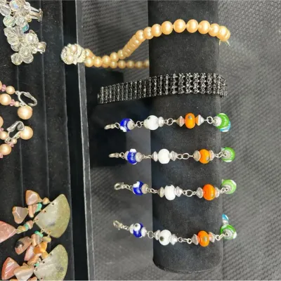 Costume Jewelry Assortment With Rosary In Case & Broaches 