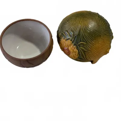 Sale Photo Thumbnail #302: Two-piece ceramic trinket box featuring a textured, flower-embossed spherical lid and a unglazed brown base with a white interior.